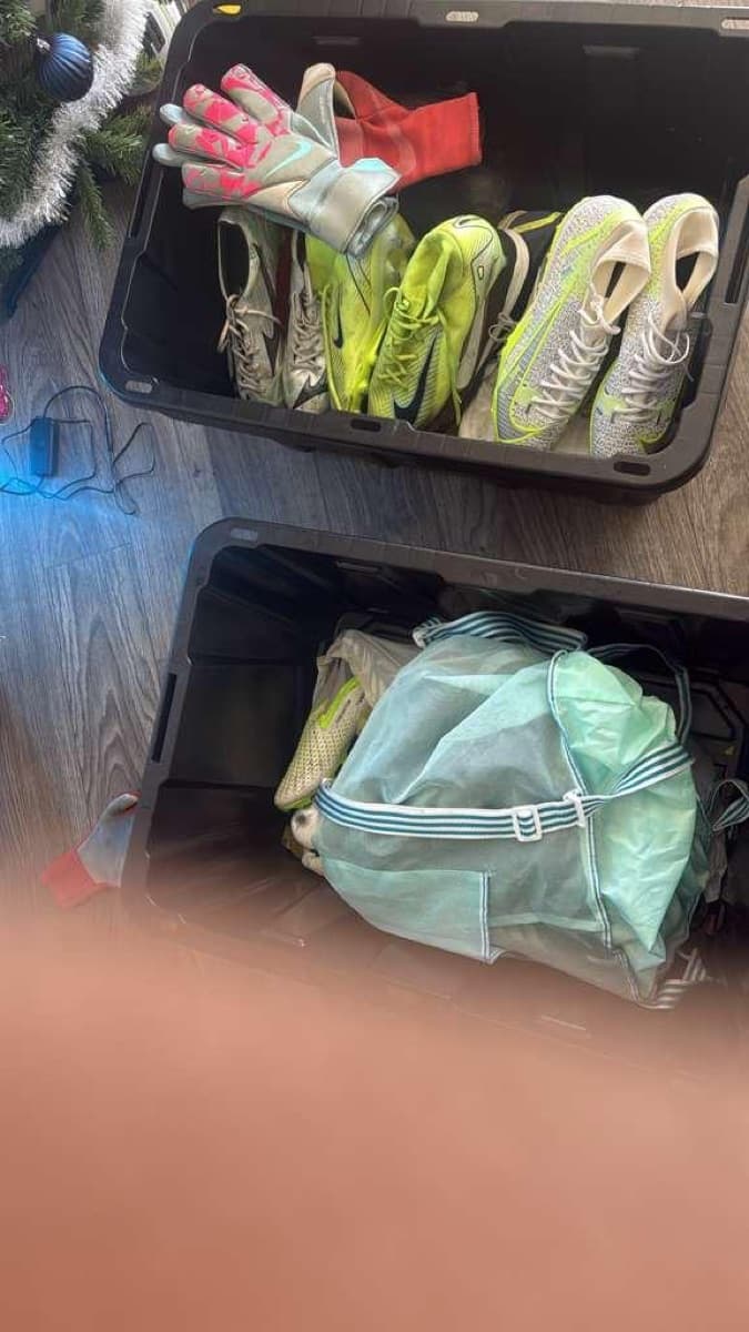 Bins of donated boots and keeper gloves, packed and ready to travel